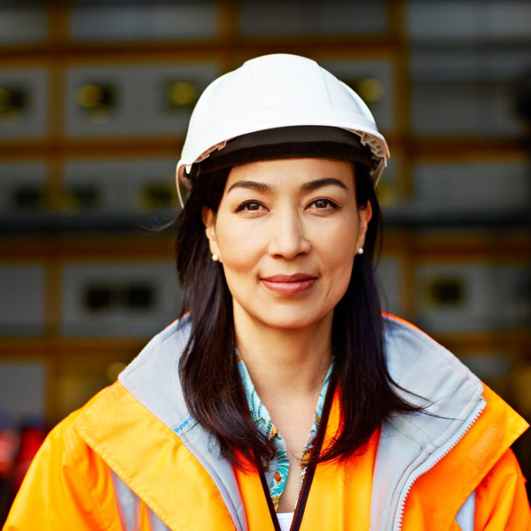 Portrait of a woman in workwear standing on a commercial dock